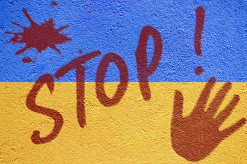 Ukraine flag painted on old concrete wall with STOP inscription