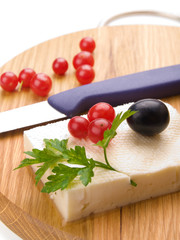 feta cheese and cranberries on wooden cutting board