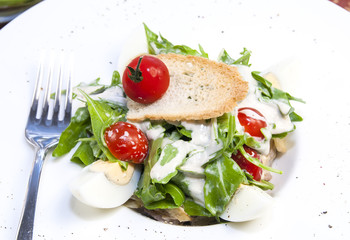 salad with eggs and vegetables with sauce in a restaurant