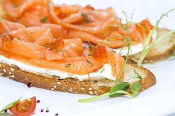 sandwiches with salmon caviar and greens adorned