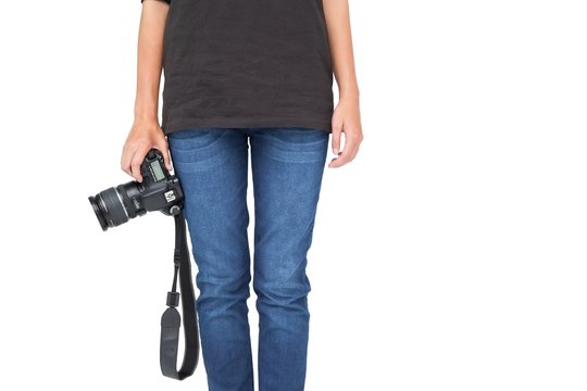 Mid section of a woman holding camera