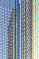 reflection of the sun in the facade of a skyscraper