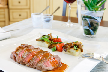 Sliced medium rare roast beef and gravy