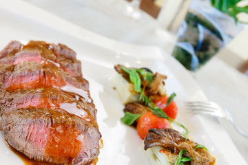 Medium rare beef with gravy and vegetables