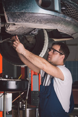 Car mechanic working in auto repair service