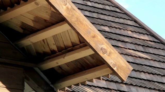 The oiled cedar wooden shingle roof of the house shake