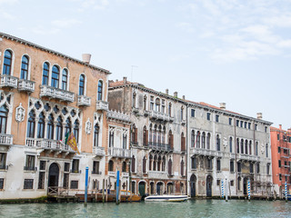 Fototapeta na wymiar Boats Moored Outside Buildings in Venice Canal