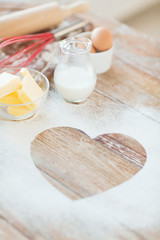 close up of heart of flour on wooden table at home