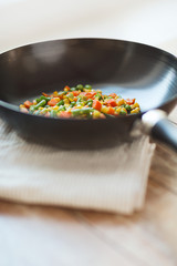 close up of wok pan with vegetables