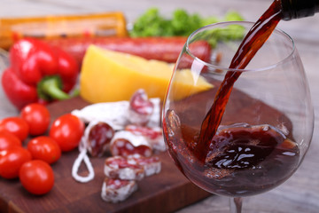 Pouring wine into glass and food background - 61725167