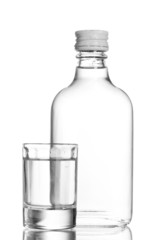 Bottle of vodka and wineglass isolated on white