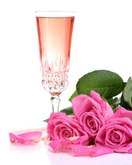 Composition with pink sparkle wine in glass and pink roses