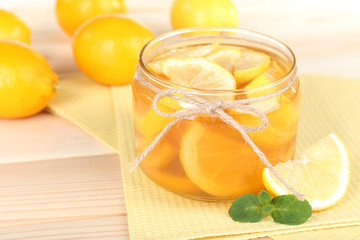 Tasty lemon jam on table close-up