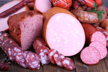 Lot of different sausages on wooden table close-up