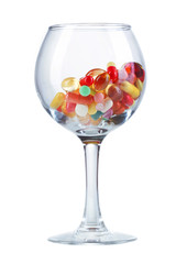 Goblet with pills isolated on white