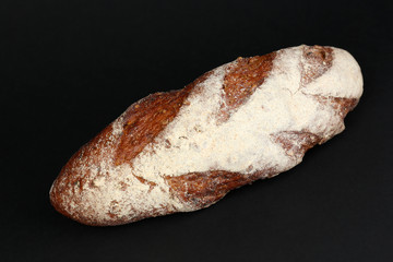 Loaf of bread on black background