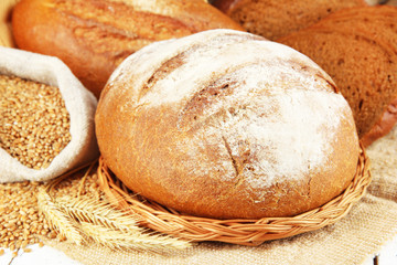 Rye bread with grains on sackcloth on table close up