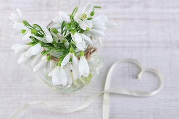 Bouquet of beautiful snowdrops on wooden background