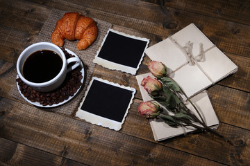 Obraz na płótnie Canvas Coffee cup, letters, dry flowers and old blank photos,