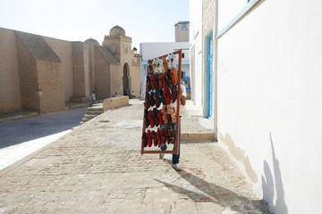 A muslim man selling shoes