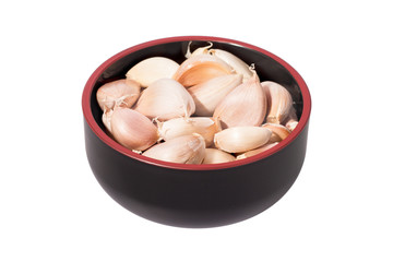 garlic in the black bowl isolated on white