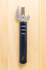 Can opener on wood background