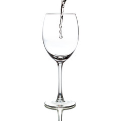 white wine pouring into a glass