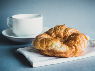 breakfast with croissants, cup of black coffee