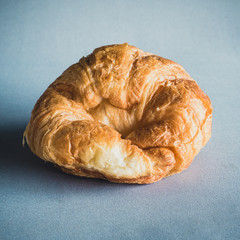 fresh croissants on gray background