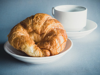 breakfast with croissants, cup of black coffee