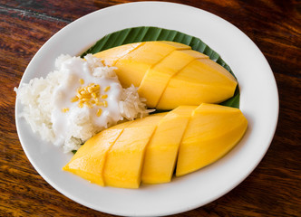 Thai style tropical dessert, glutinous rice eat with mangoes