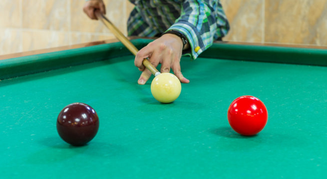 Young man playing snooker. Billiard