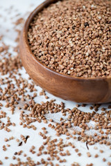 Close-up of raw buckwheat kernels, vertical shot