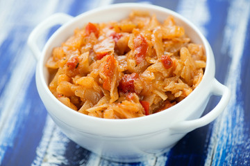 Close-up of stewed cabbage, blue wooden background