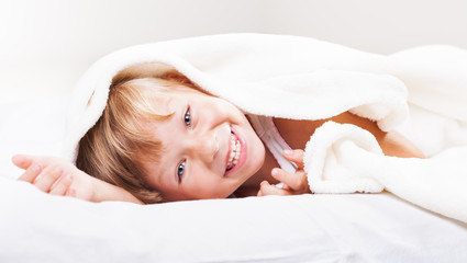 Fototapeta na wymiar Cute little girl in the bed.