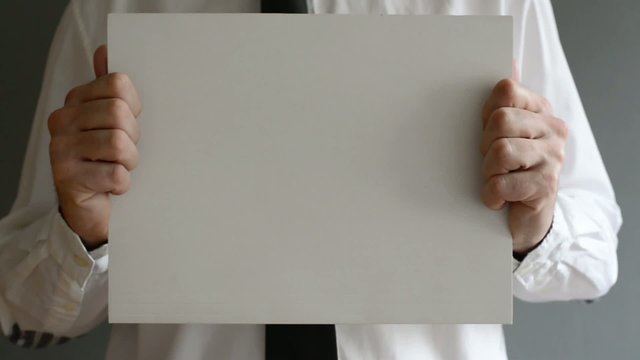 Businessman holding blank paper with copy space