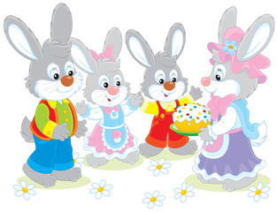 Family of rabbits with an Easter cake
