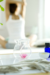 Aroma herb on sideboard and woman stretching