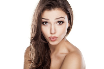 Fototapeta premium Young beautiful woman with kissing gesture