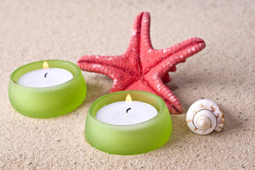 Fototapeta na wymiar sea shell and candle romantic set on the beach