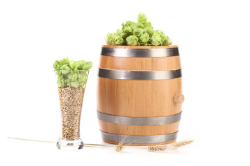 Barrel and glass with hop barley.
