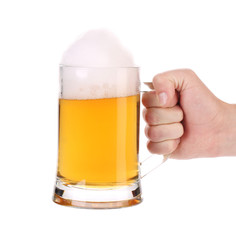 Man hand holds beer in mug.