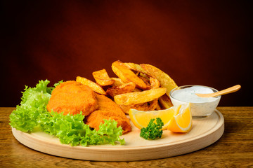 Fish and chips on a wooden plate
