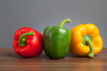 Raw peppers, multiple colors, on table