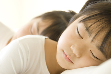 Fototapeta na wymiar Japanese sisters taking nap