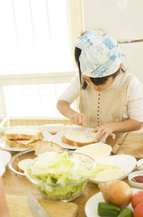 Japanese daughter cooking in kitchen