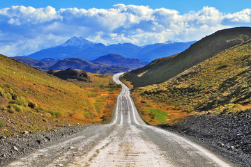 The road goes to snow-covered black rocks - Powered by Adobe