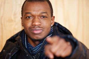 Fototapeta premium Black guy points with finger
