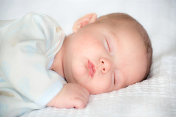 Infant baby boy sleeping peacefully