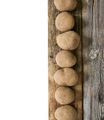 Fototapeta na wymiar Potatoes on wooden board